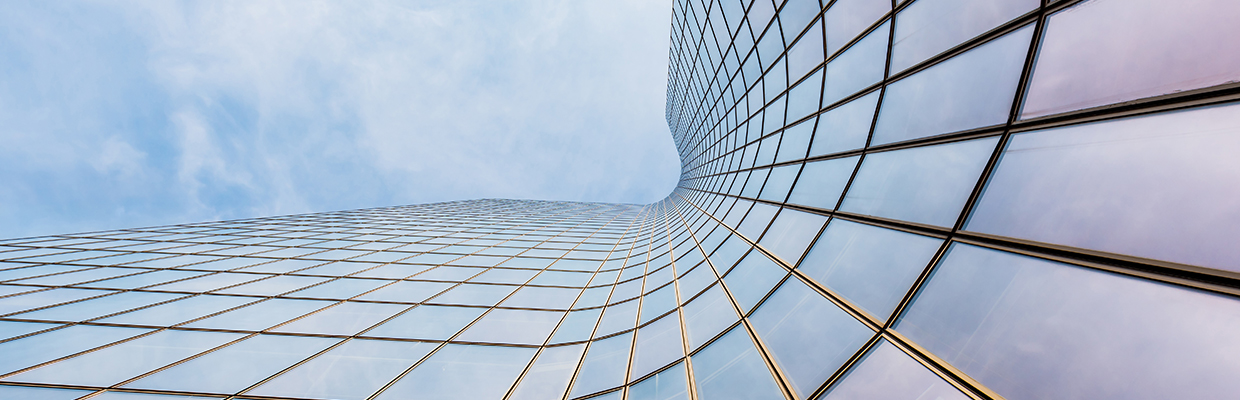 Curved skyscraper against blue sky