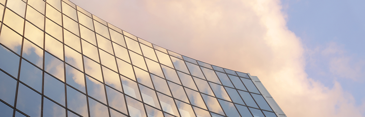 Top of a building reflecting clouds