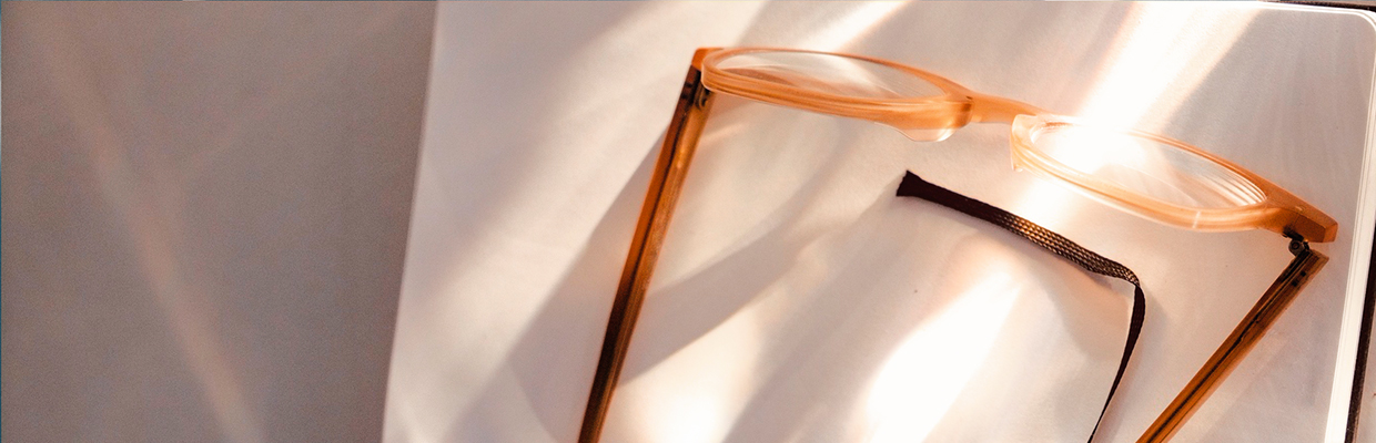 Shading light on glasses on a white double page of a note book