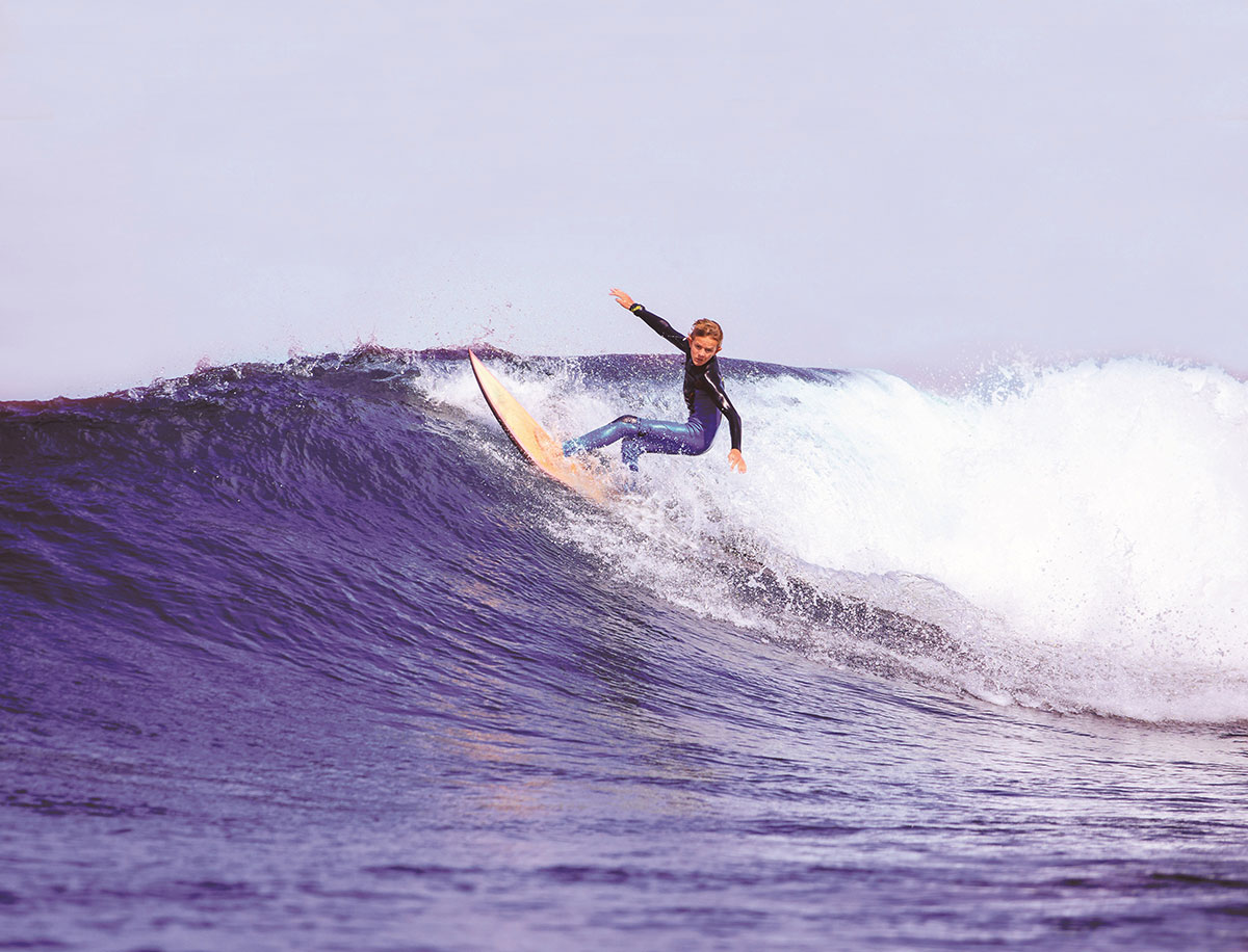 Woman surfing ocean wave