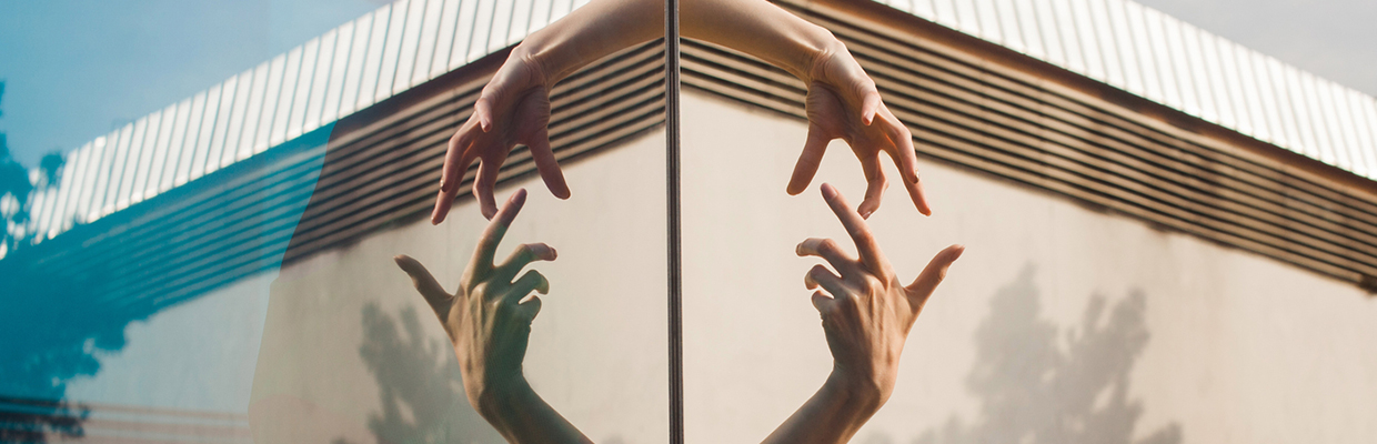 Reflection of two reaching hands