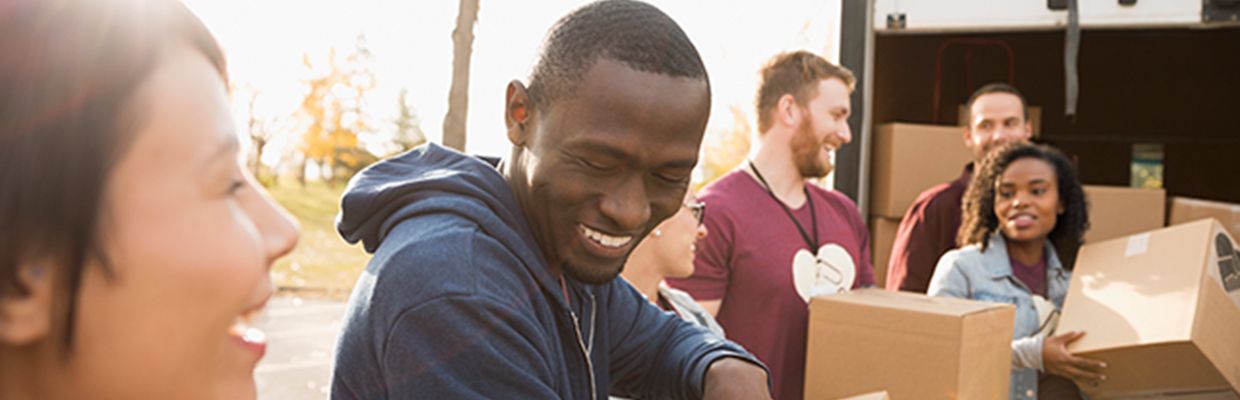 Group of young adults moving boxes